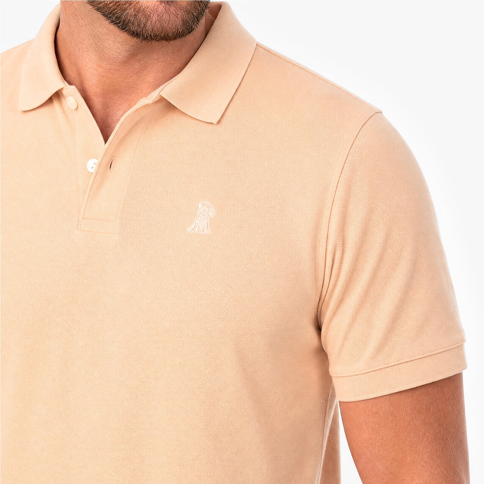 Beige polo shirt with a small logo on a white background