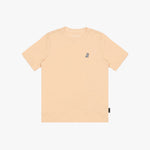 A light peach T-shirt with a small embroidered logo on the left chest, displayed flat against a white background.