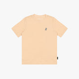 A light peach T-shirt with a small embroidered logo on the left chest, displayed flat against a white background.