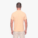 Man wearing a beige polo shirt on a white background