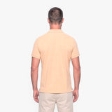 Man wearing a beige polo shirt on a white background