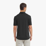 Man wearing a black polo shirt on a white background