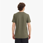 Back view of a man wearing a green t-shirt on a white background