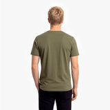 Back view of a man wearing an olive green t-shirt on a white background