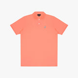 Coral polo shirt with a small logo on a light gray background