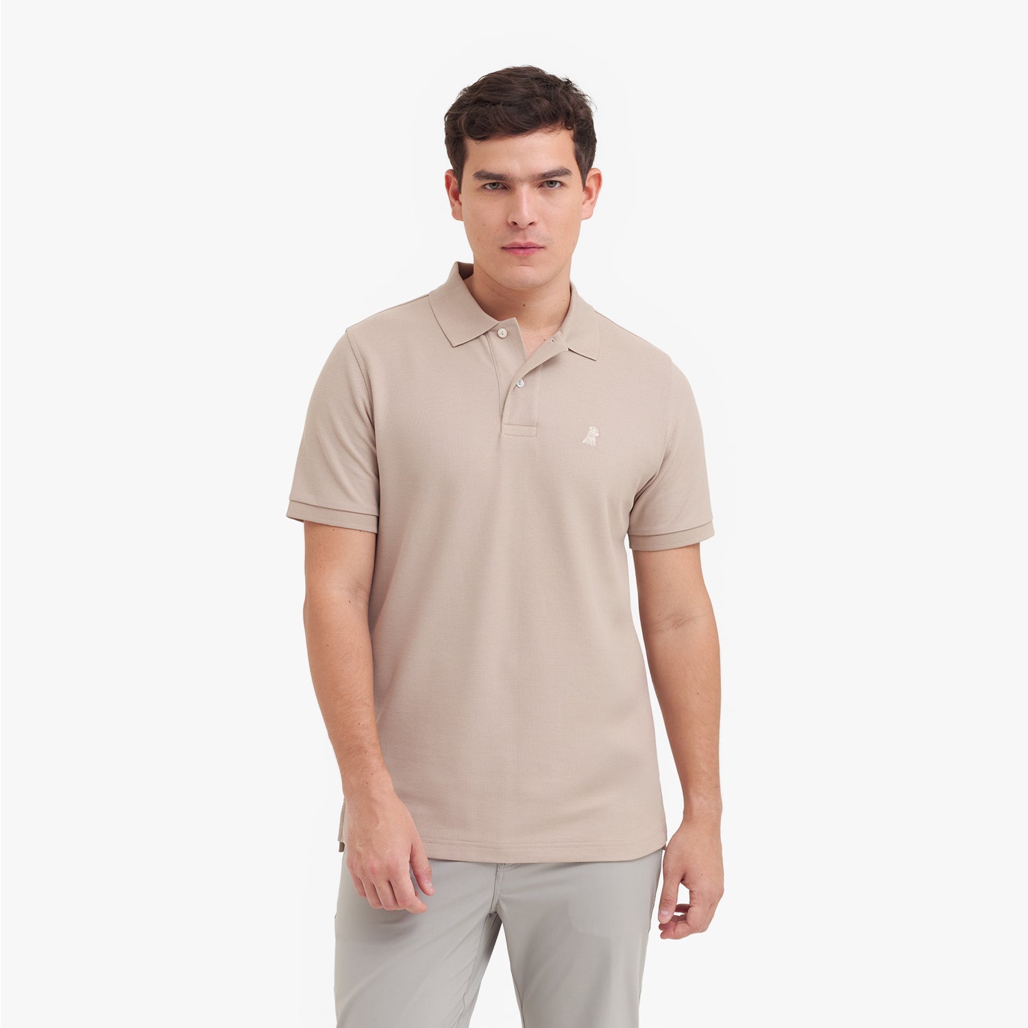 Man wearing a beige polo shirt on a white background