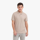 Man wearing a beige polo shirt on a white background