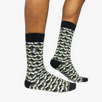 Patterned socks with black accents worn by a person on a white background