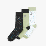 Three pairs of socks in black, green, and white with dog patterns on a white background