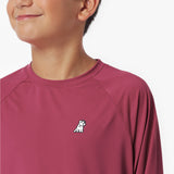 Close-up of a maroon long-sleeve rashguard with a small logo