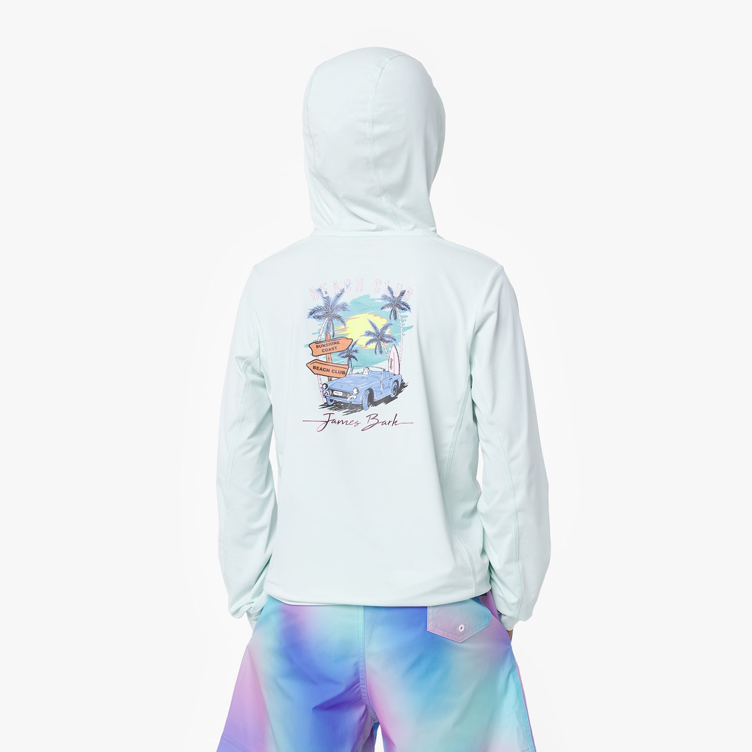 Boy wearing a light blue rashguard with a colorful graphic on the back