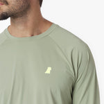 Close-up of a light green long-sleeve rashguard with a small logo