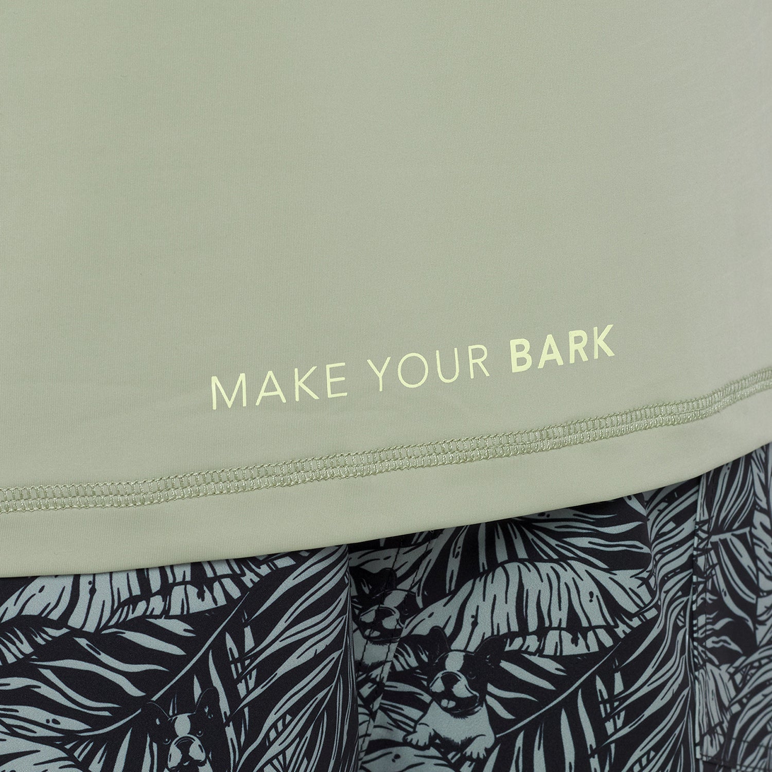 Text 'MAKE YOUR BARK' on a light green rashguard