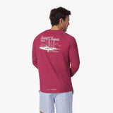 Back view of a man wearing a red long-sleeve rashguard with 'Saint Tropez, France' print on the back
