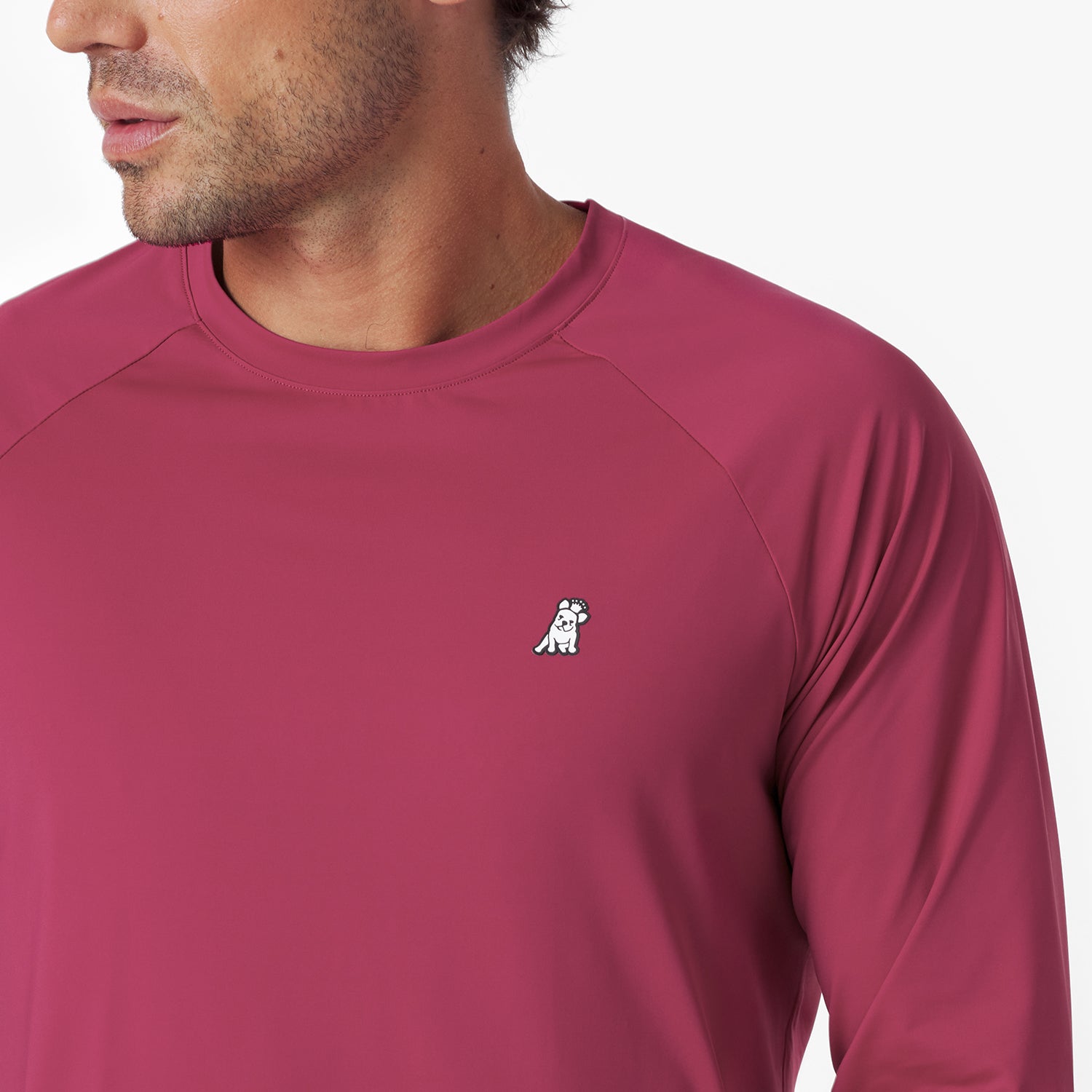 Close-up of a maroon long-sleeve rashguard with a small logo