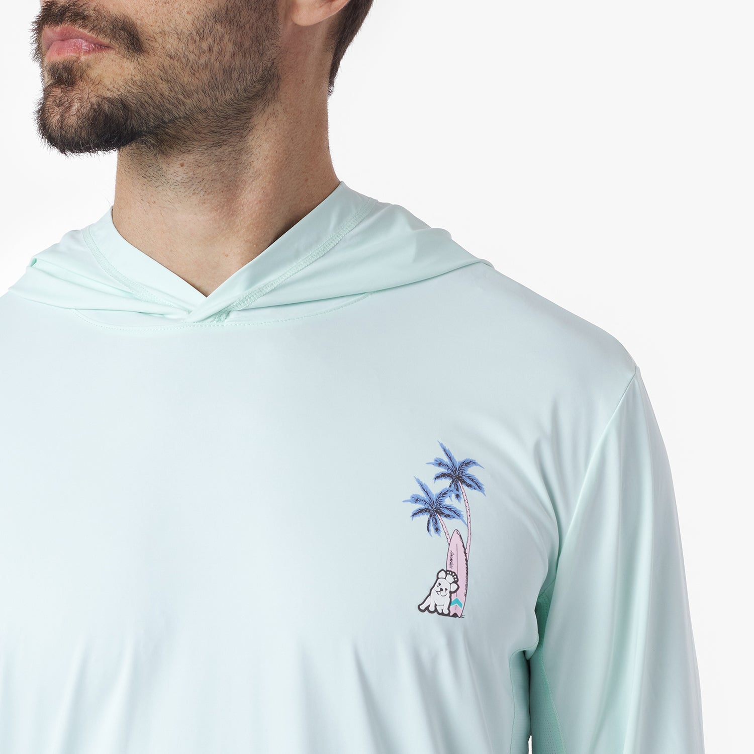 Close-up of a light blue hoodie with a palm tree and surfboard design
