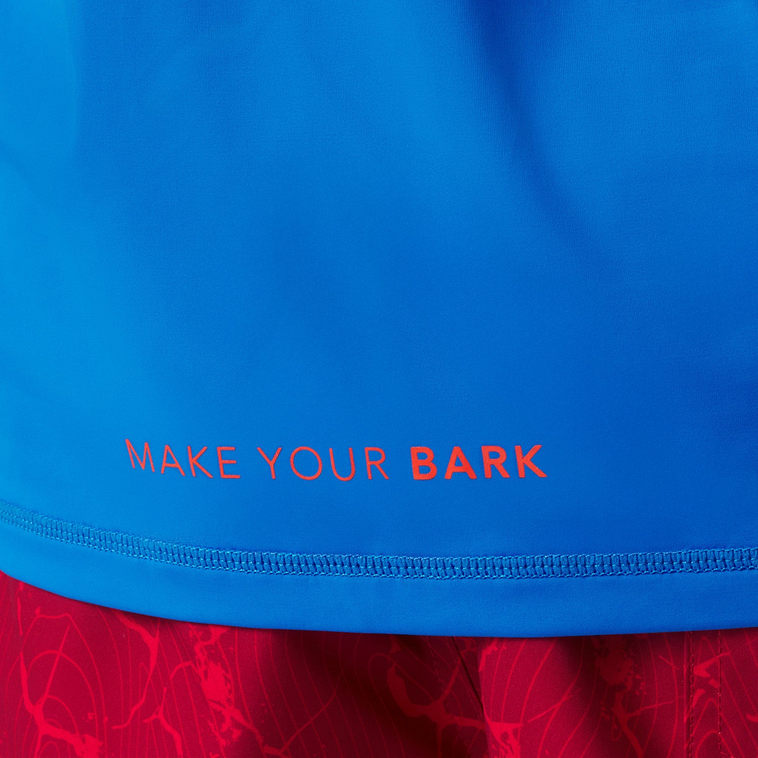 Blue rashguard with 'MAKE YOUR BARK' text