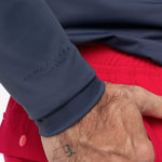 Close-up of a man wearing a navy rashguard with 'James Bark' branding