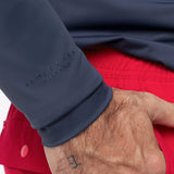 Close-up of a man wearing a navy rashguard with 'James Bark' branding