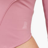 Close-up of a pink athletic rashguard with a brand logo