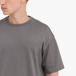 Close-up of a gray t-shirt with 'JAMES BARK' logo on a white background