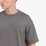 Close-up of a gray t-shirt with 'JAMES BARK' logo on a white background