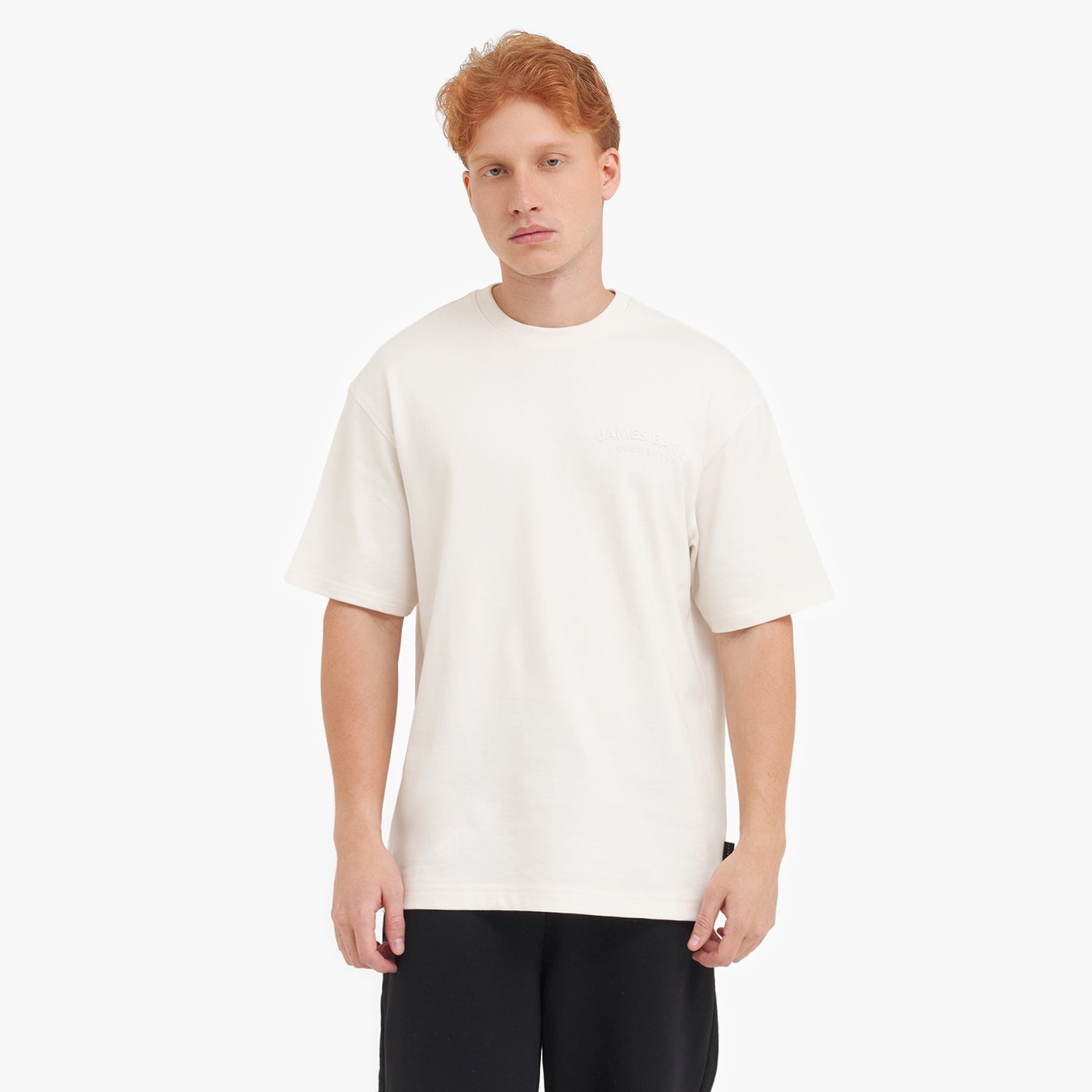 Man wearing a white t-shirt and black pants on a white background