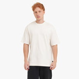 Man wearing a white t-shirt and black pants on a white background