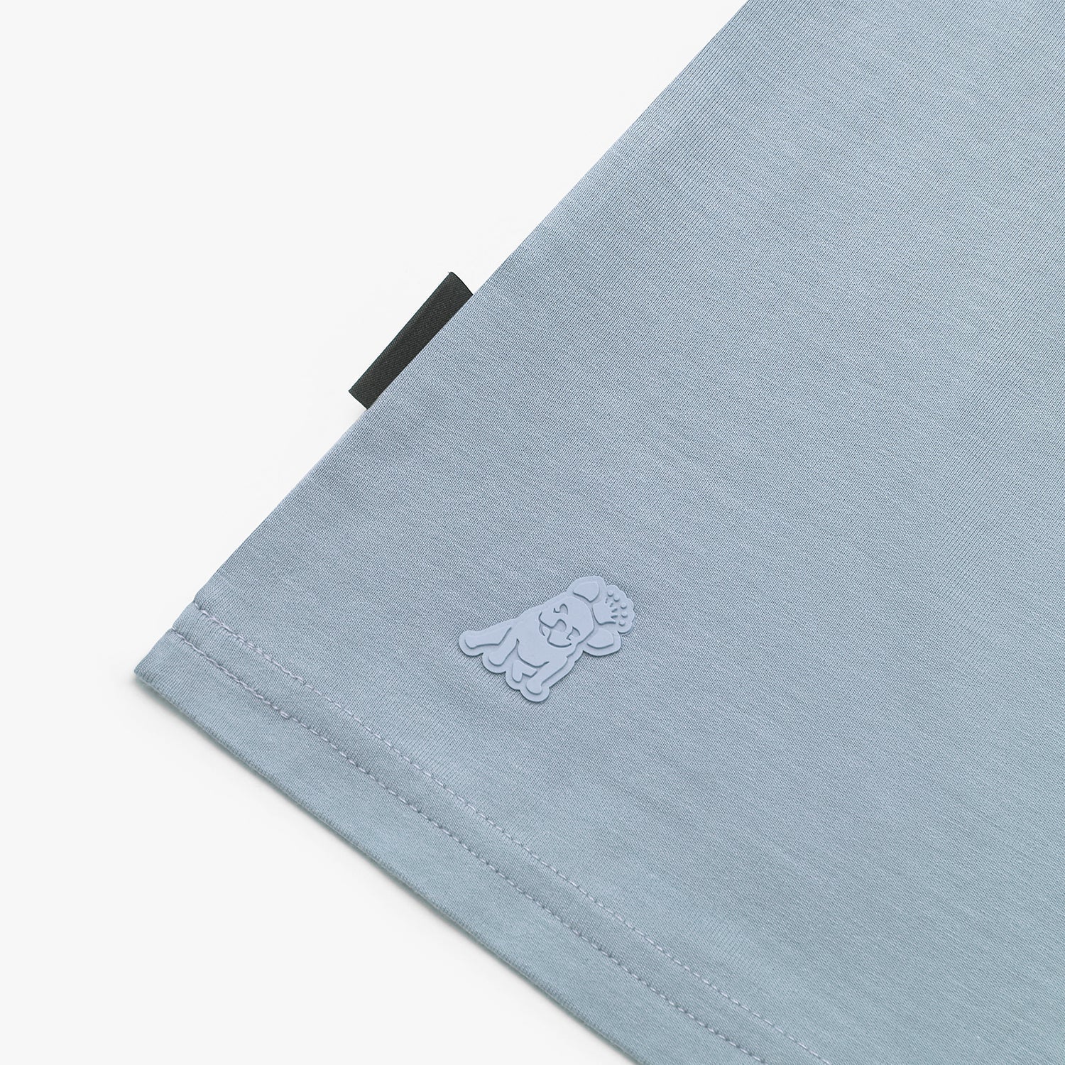 Close-up of a light blue fabric with a logo on a white background