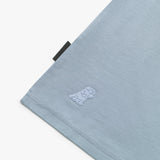 Close-up of a light blue fabric with a logo on a white background