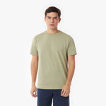 Man wearing a light green t-shirt on a white background