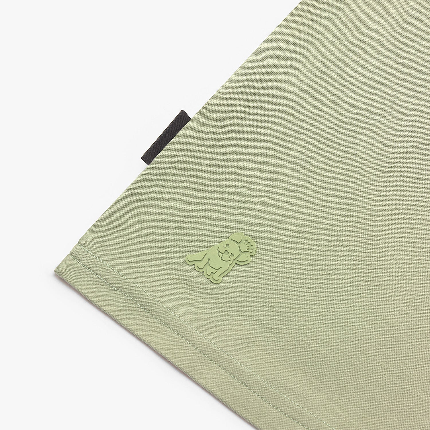 Close-up of a green fabric with a logo on a white background