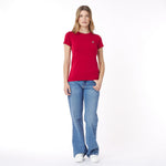 Woman wearing a red t-shirt and blue jeans on a white background