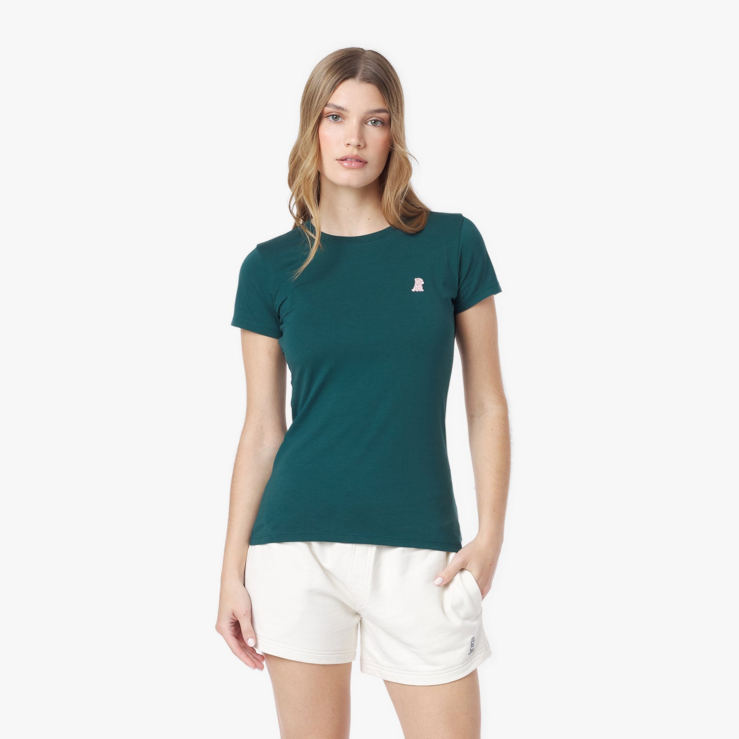 Woman wearing a green t-shirt with a small logo on a white background