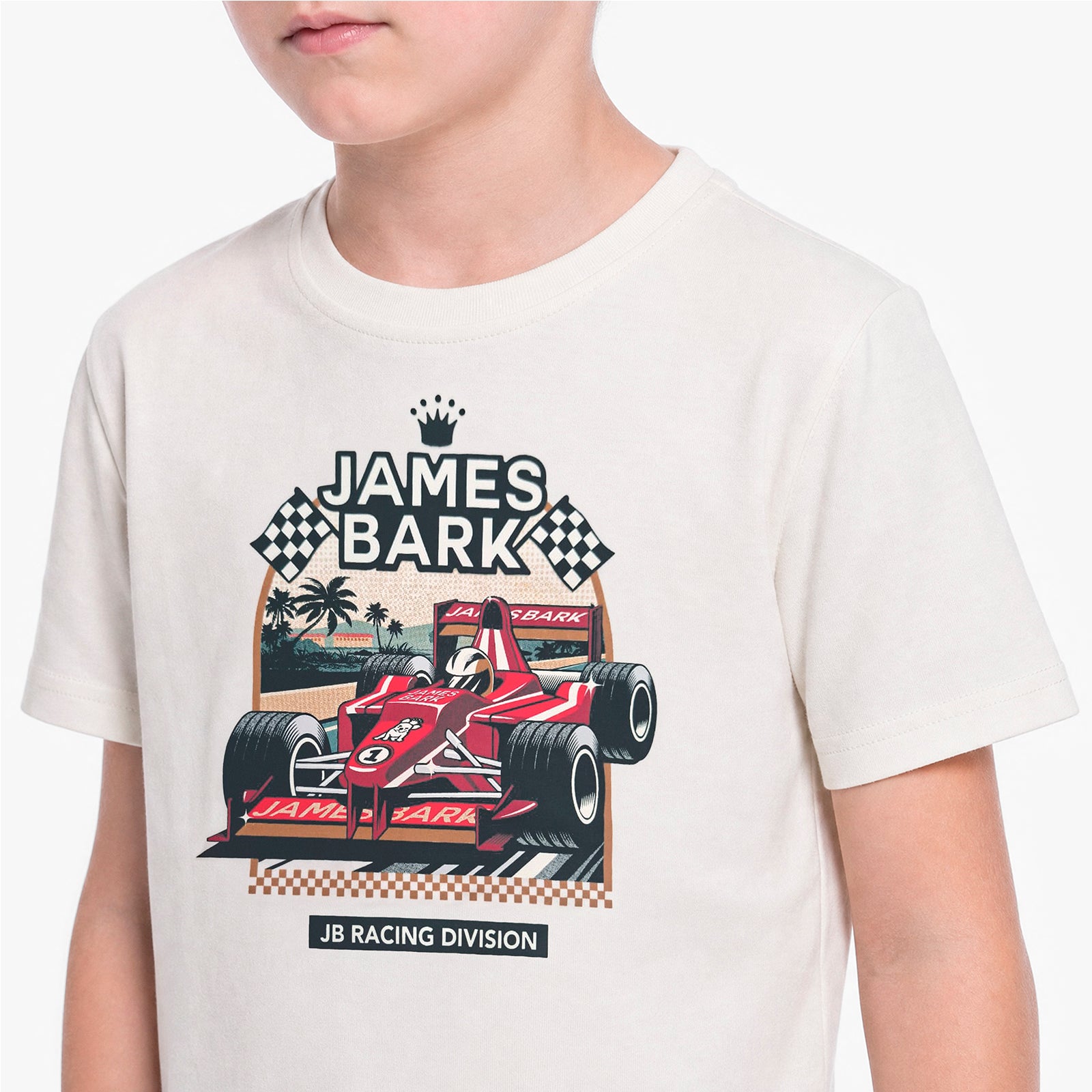 A child wearing a cream-colored t-shirt with a graphic print of a red James Bark Formula 1 car and checkered flags.