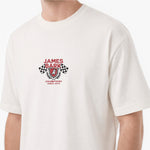 A close-up of a person wearing a white short-sleeve t-shirt with a red and black James Bark Champions graphic on the chest.