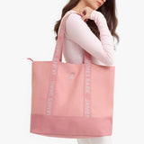 Pink tote bag with 'James Bark' branding held by a person