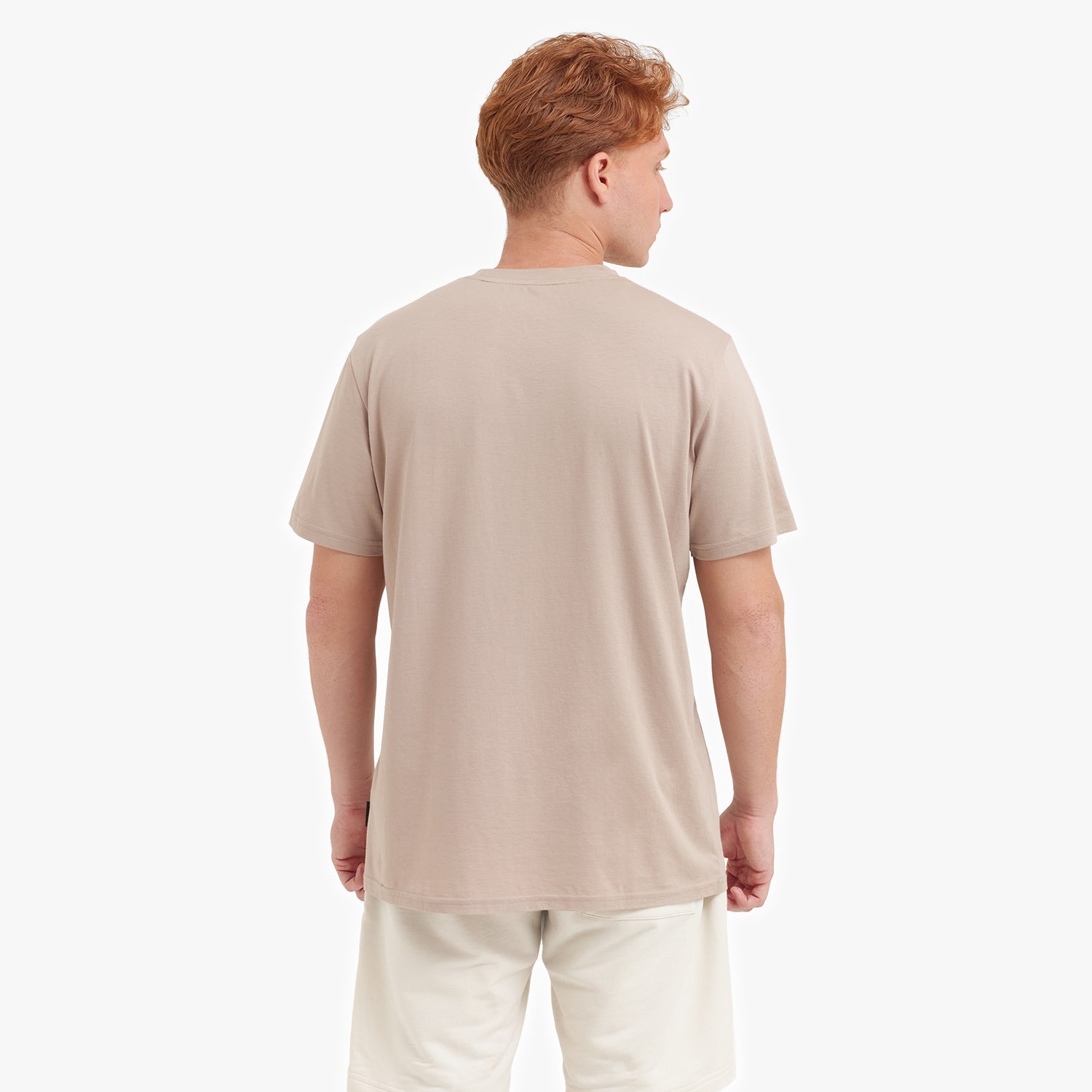 Back view of a man wearing a beige t-shirt on a white background