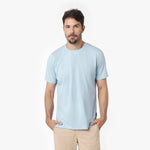 Man wearing a light blue t-shirt against a white background