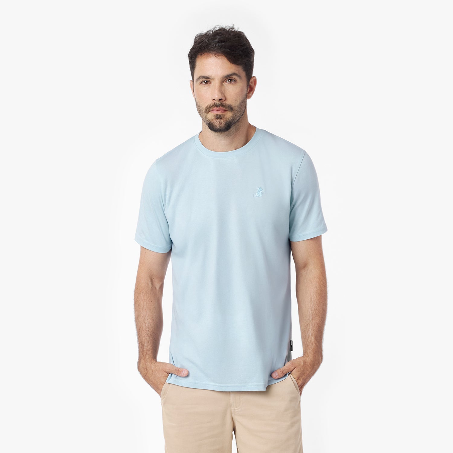 Man wearing a light blue t-shirt against a white background