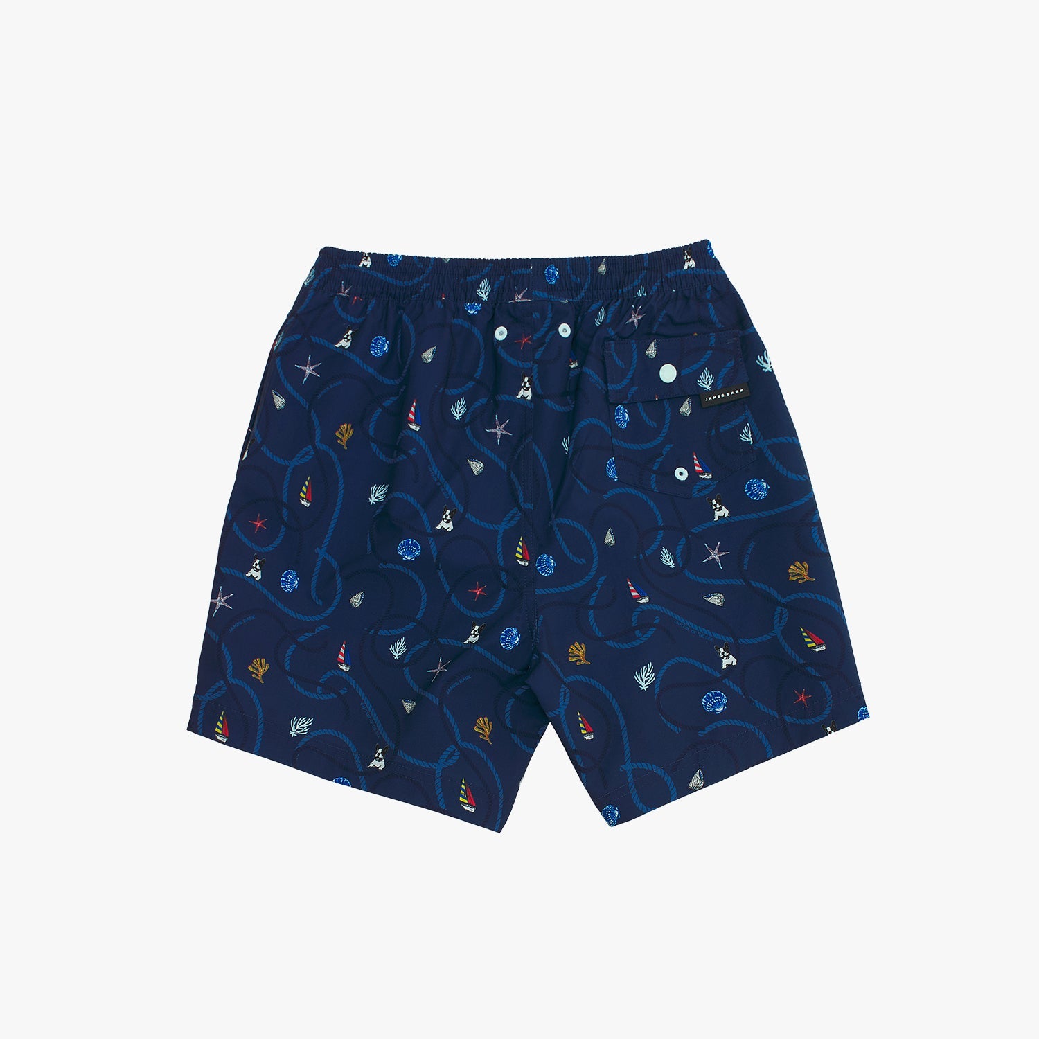 Back view of the navy blue nautical print swim trunks, showing the elastic waistband and a back flap pocket with a white snap closure