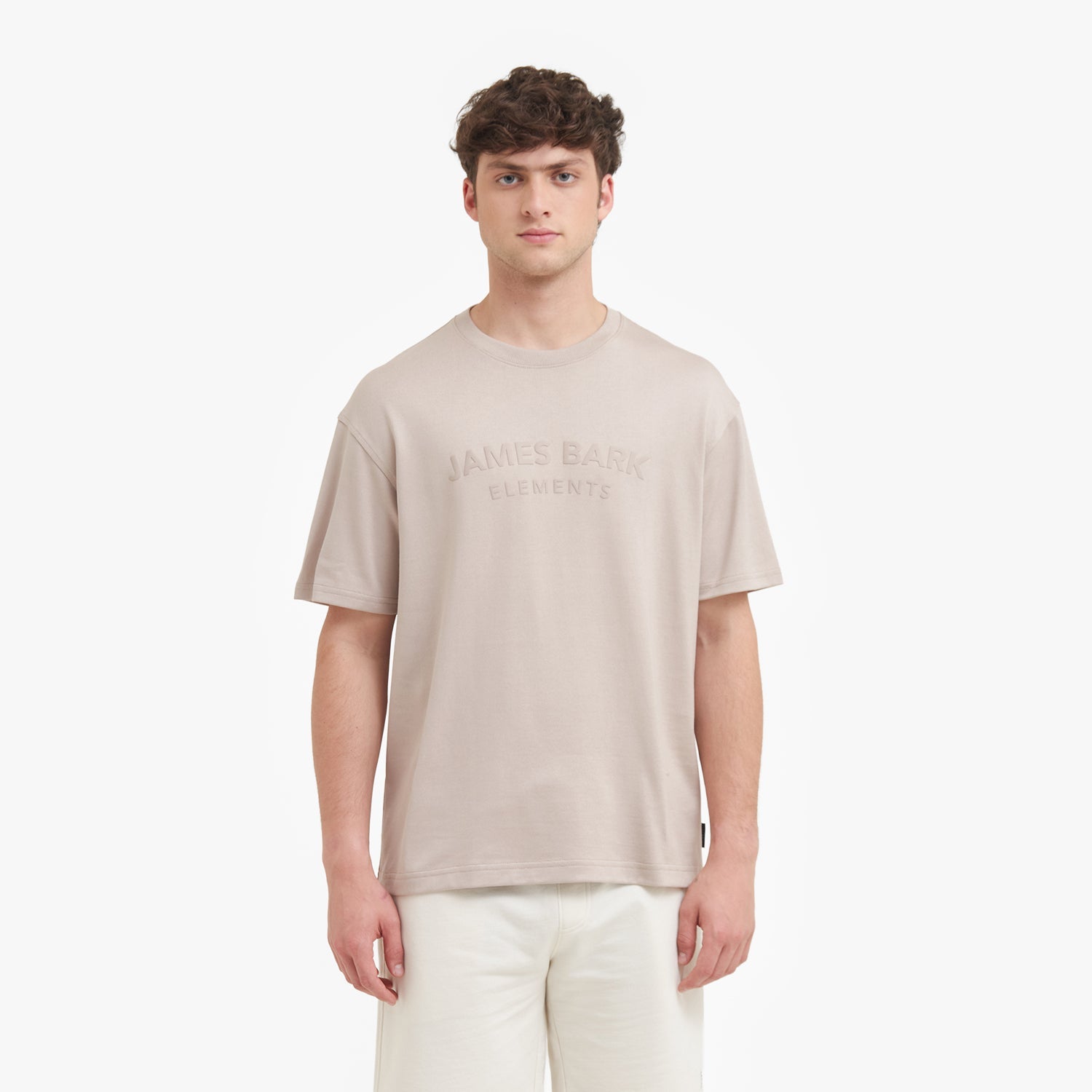 Man wearing a beige t-shirt with text on a white background