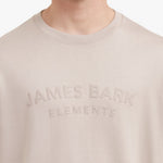 Close-up of a beige sweatshirt with 'James Bark Elements' text on a white background