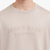 Close-up of a beige sweatshirt with 'James Bark Elements' text on a white background