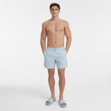 A shirtless male model wearing light blue swim shorts with a yellow drawstring and matching light blue slide sandals