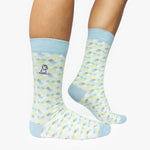 Patterned socks with light blue accents worn by a person on a white background