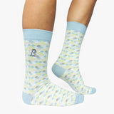 Patterned socks with light blue accents worn by a person on a white background