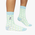 Patterned socks with light blue accents worn by a person on a white background