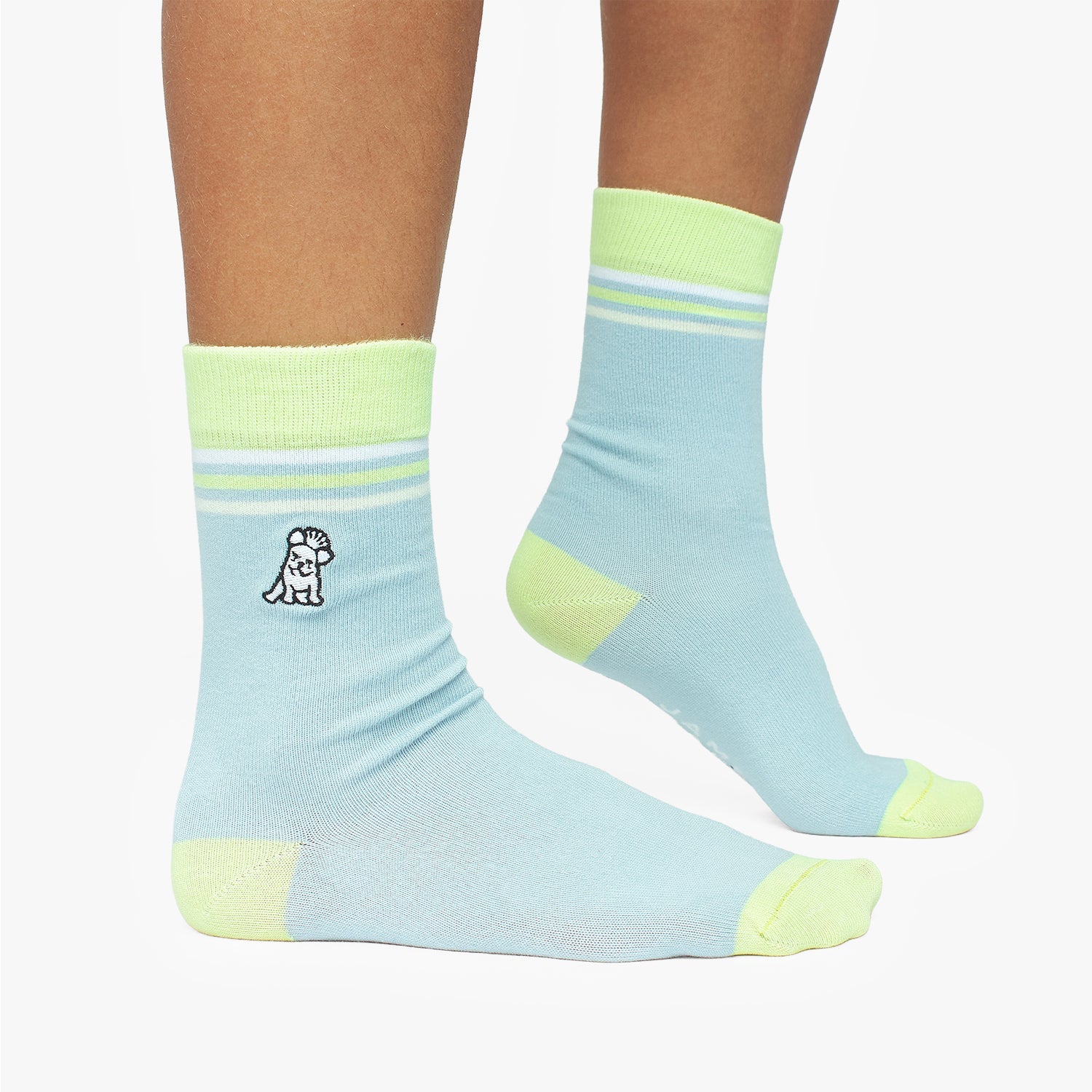 Light blue socks with green accents worn by a person on a white background