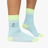Light blue socks with green accents worn by a person on a white background